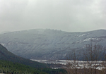 Snow covered trees on the hills nearby